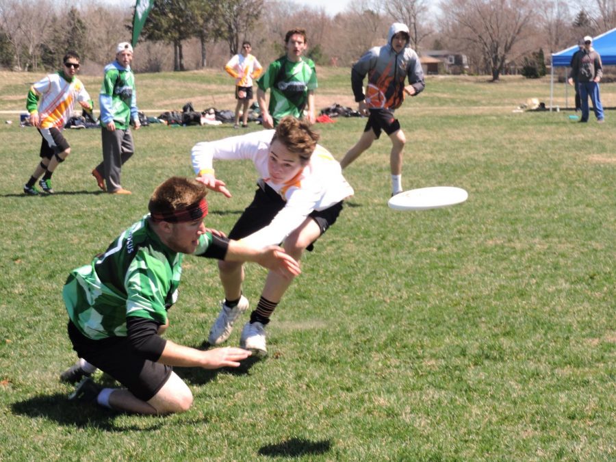 Junior Boden Oelhafen attempts to defend the disc at the Madison Mudbath Ultimate Tournament for Park April 28.