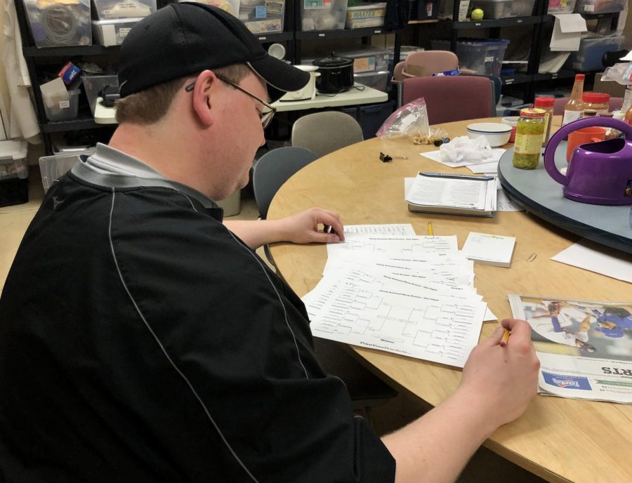 Science teacher Peter Dangerfield tallies up votes on Disney-themed brackets May 2. 