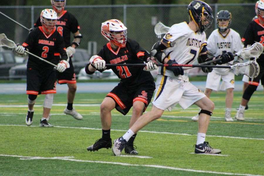 Senior Liam O'Neil tries to block Breck player Senior Brendan at 7 p.m. game at Breck on May 11. 