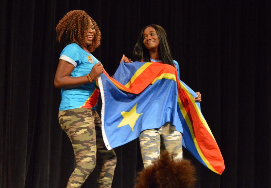 Sophomore Rosilia Lokenye wears her Democratic Republic of the Congo soccer jersey and carries their flag. 