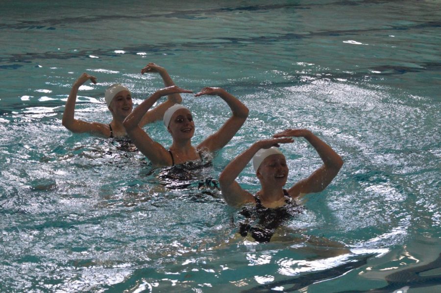 Senior Savannah Kjaer and sophomores Annie Breyak and Ella Hammerstrand perform their trio at a synchronized swimming meet at Blake High School on April 27. 