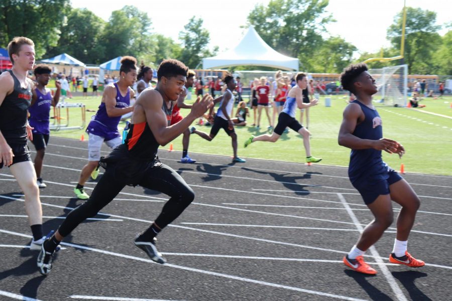 Senior Skyler Rudelius-Palmer hands the baton off to Senior Karon Adams as they run the 100 meter relay at Sections May 31. 
