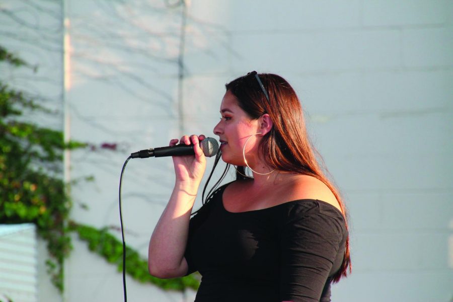 Senior Cecilia Brown sings at the Nest street party Aug. 15. There were also performances by Dan Israel, Neb Bekele and Dopeamine.