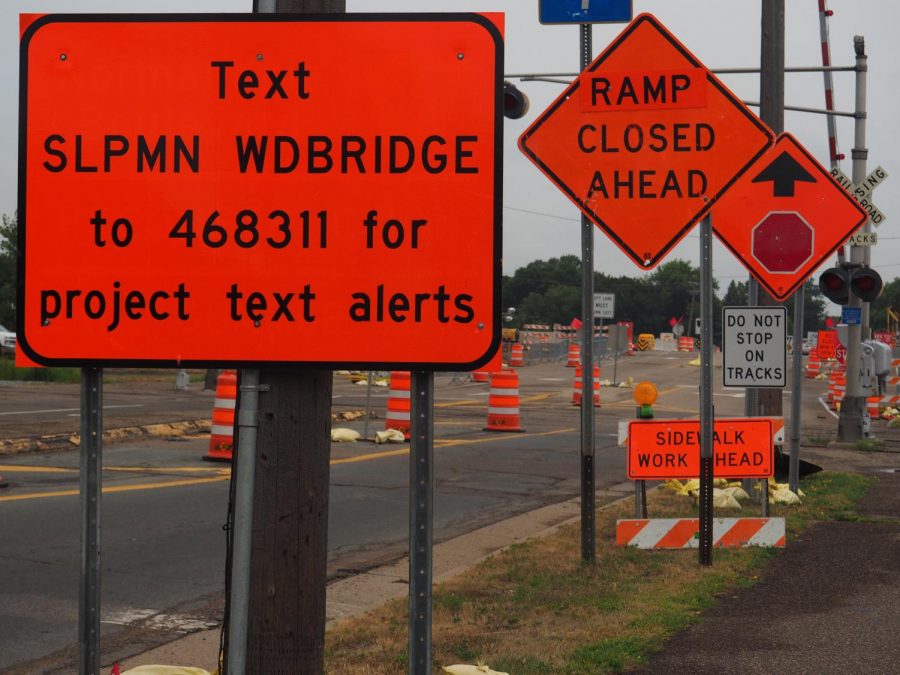 Signs and cones distract drivers on Wooddale Bridge. The bridge construction causes traffic buildup and confusion with many new signs and driving precautions. 