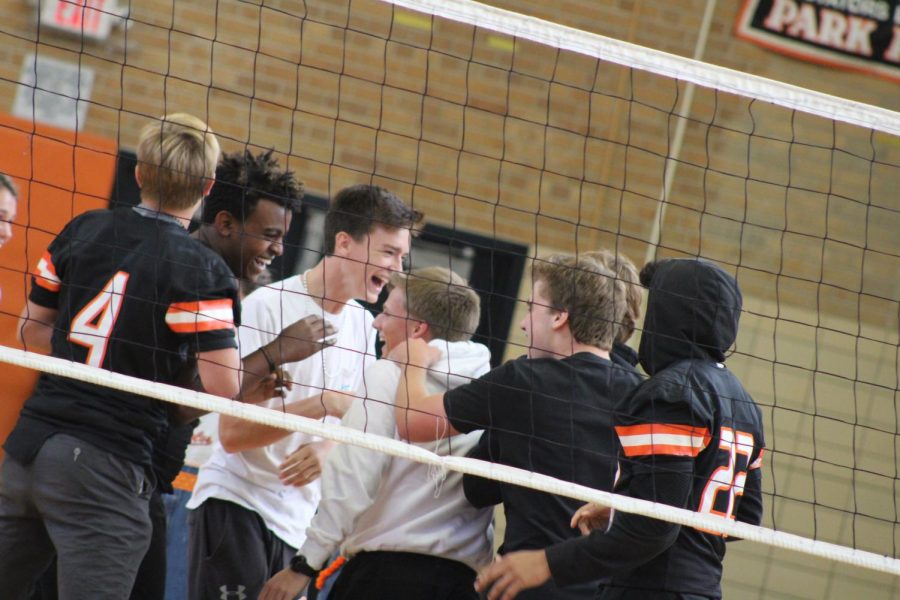 Seniors Will Hannon, Milkaso, Hans, Adam Bauer and John Meyer huddle in excitement after winning the volleyball game. The students vs. teachers volleyball game took place at the second pep feasts this year.