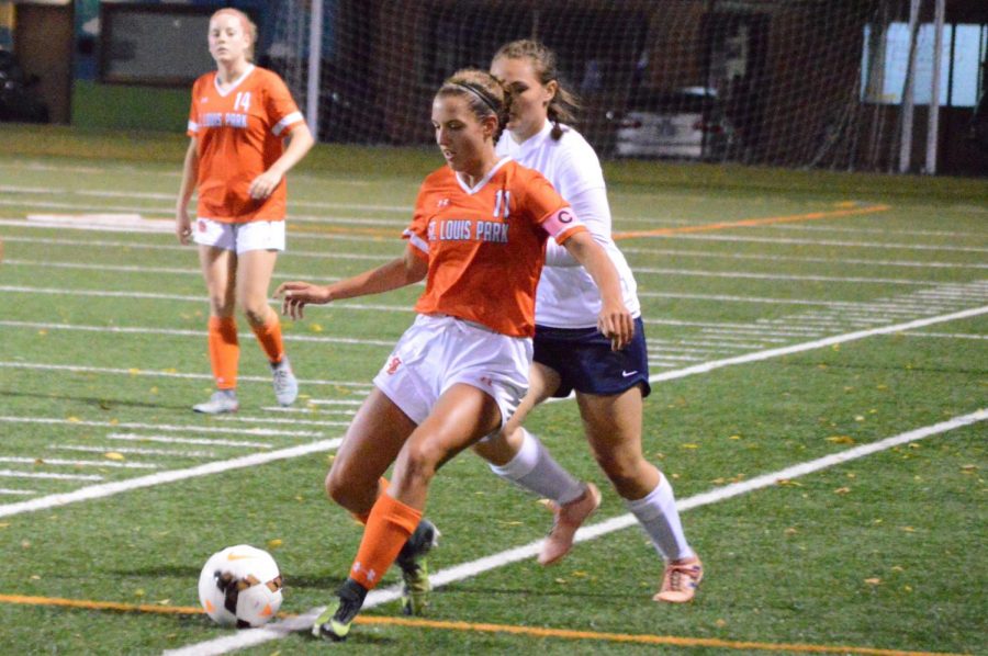 Girls soccer captain, junior Ava Bishop, dribbles the ball along the side lines toward the opponents goal. Bishop played left wing for the majority of the game Sept. 17.