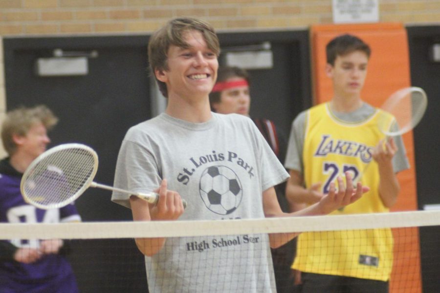 Senior Isaak Kimmel celebrates winning a point for his for team for the badminton Homecoming tournament. 