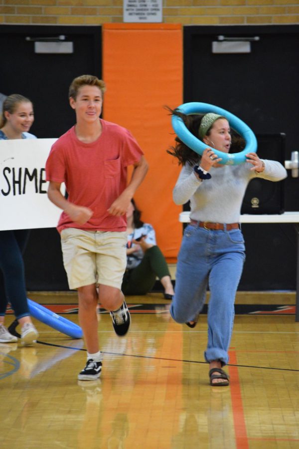 Freshman Oliver Smith and Anna Overall run in a relay competition against the other grades as apart of the Day One festivities. 