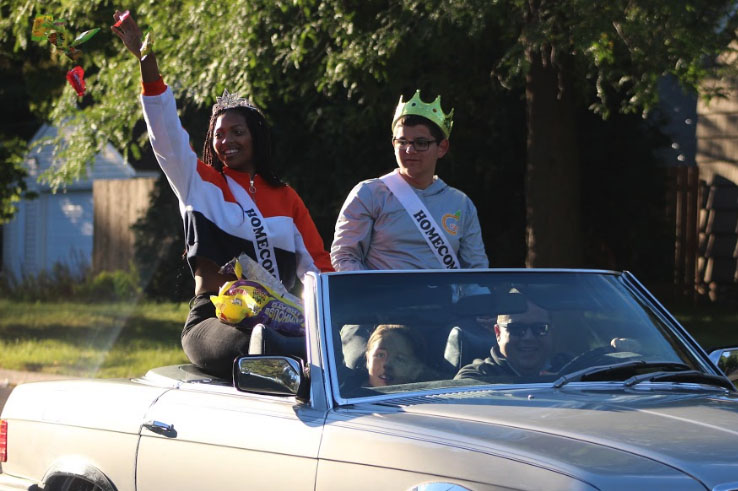 Homecoming queen Jada Witherspoon and king Daniel Hunegs ride on the back of a convertible during the homecoming parade Sep 21. 