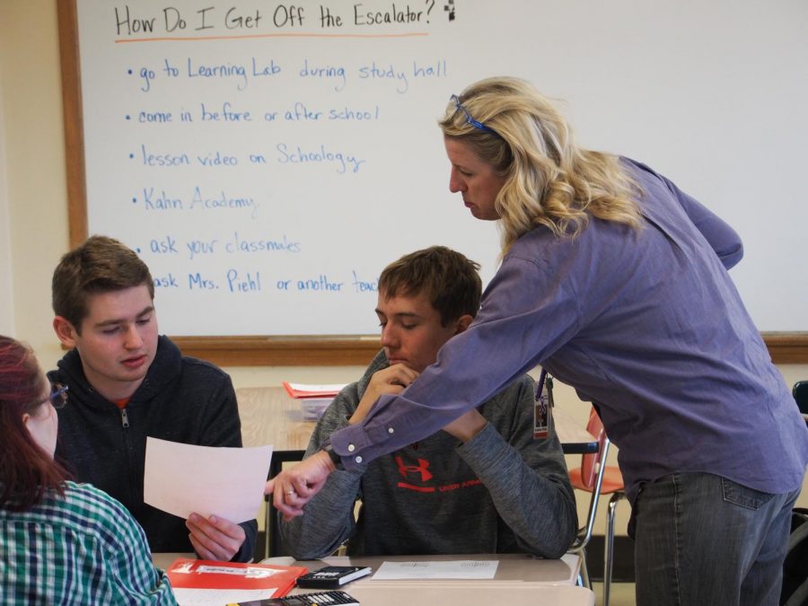 Keisha Piehl helps students in her Advanced Algebra AB class. Piehl tries to leave time at the end of each class for students to ask questions.