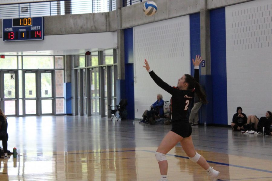 Sophomore Olivia Lainsbury serves the ball to the opposing team. The volleyball team played in the Hopkins tournament Oct.6, finishing the day with a score of 2-2.