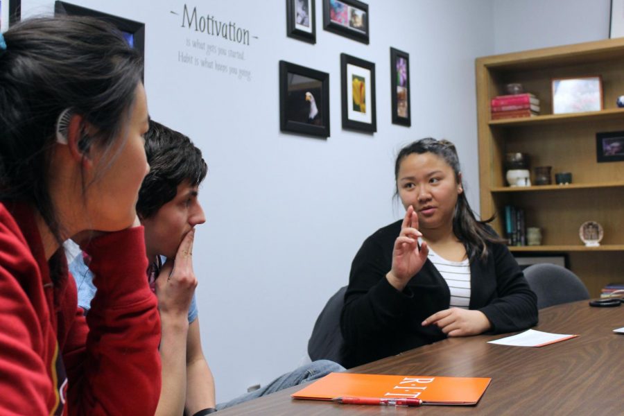 Seniors Anna Kasper and Alessandro Giannetti meet with Rochester Institute of Technology Nov. 15. RIT representative Lian Jackson speaks to the students through sign language.  