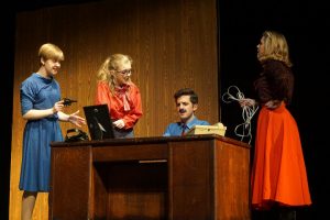 Sophomore  Phoebe McKinney, junior Isaac  Wahl and seniors Evie Nelson and Emma Yarger, perform a scene from 9 to 5 the Musical. Opening night for the musical took place Nov. 9th with more performances to come Nov. 11, 16, 17 and 18. 
