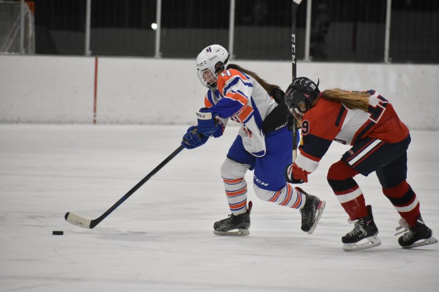 Sophomore Abby Meyer keeps the puck away from an Orono player Oct. 10. Hopkins Park ended with a final score of 6-3.