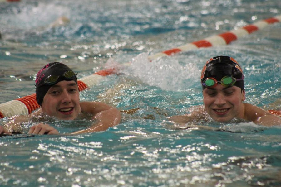 Senior Boys Swimming captains Luke Anderson and Max Bechtold practice their kicking technique during practice Nov. 26. As the captains Anderson and Bechtold lead captious practices before the season begins.  