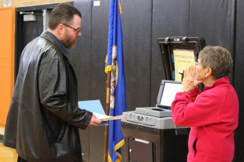 A voter converses with the woman in charge of the ballot scanner Oct. 6. All of Minnesota uses an optical scanner at voting polls. 