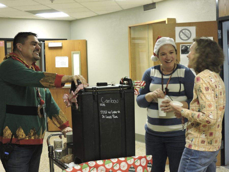 Assistant Principals Jessica Busse and Todd Goggleye deliver beverages and treats to all of the high school staff Dec. 21, around the high school. They also handed out SLP Strong bracelets made by a group of students in business innovations.