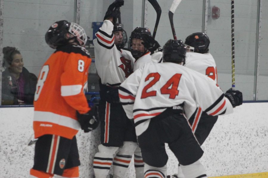 Sophmores Lucas Hand, Sam Berry, and Junior Bobby Dos celebrate after getting another goal against Osseo. 