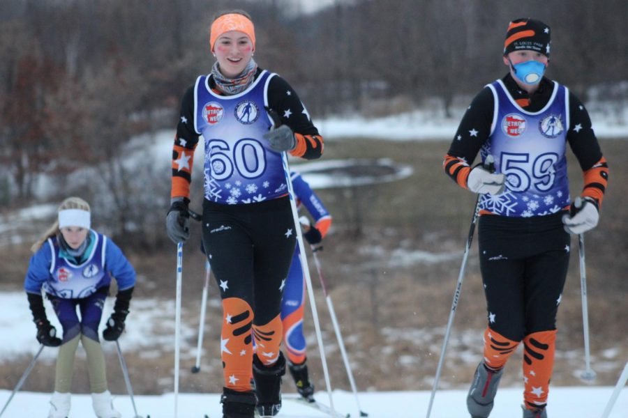 Senior Libby Ramsperger and Sophomore Marit Gabel classic ski up a hill during the meet Dec. 20 at Elm Creek. Ramsperger placed 26th and Gabel placed 31th. The girls varsity team placed first overall at the meet.  