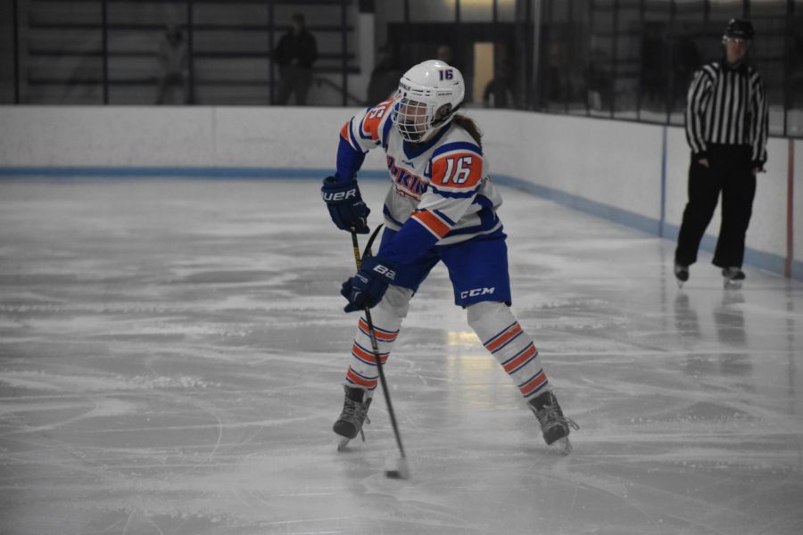 Senior Mary Gleason passes the puck to a teammate during the second period of the game.