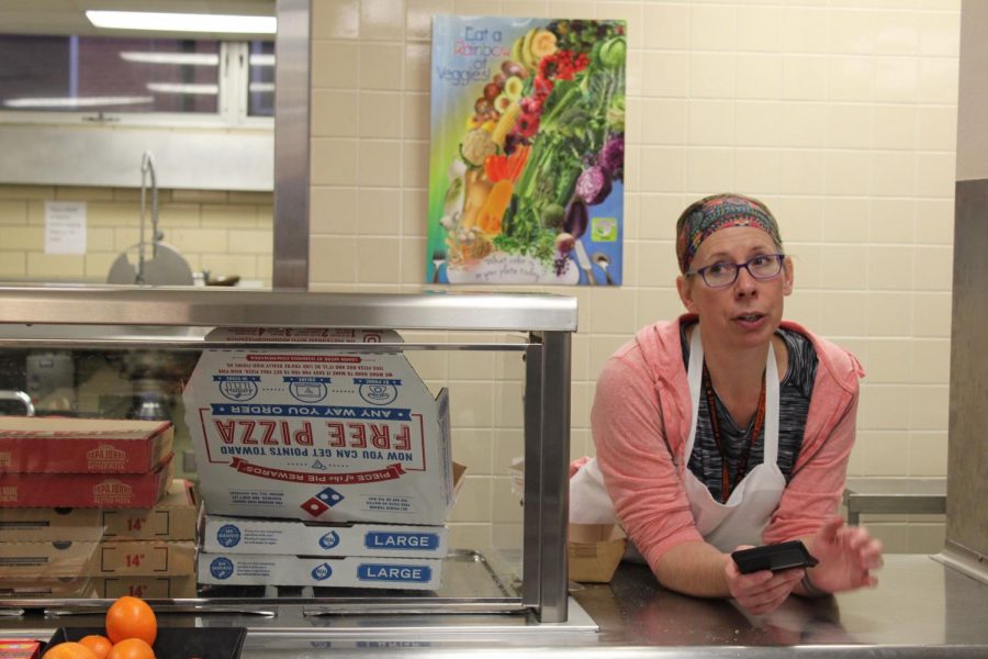 A lunch lady speaks to assistant principal Todd Googleye about how many pizzas they have distributed during first lunch. Due to the kitchen fire, lunches were unable to be prepared for students and were ordered from the nearby Dominos pizza on Minnetonka Blvd. and West Lake street Jan. 15. 