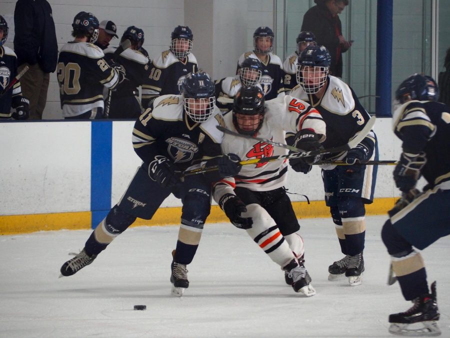 Sophomore McCabe Dvorak leans into senior Hans Lovig to gain possession of the puck. Dvorak scored once against Chanhassen in the second period and has the second most in goals with seven so far this season. Dvorak has also racked up five assists as of Jan. 9 according to MN Hockey Hub. 