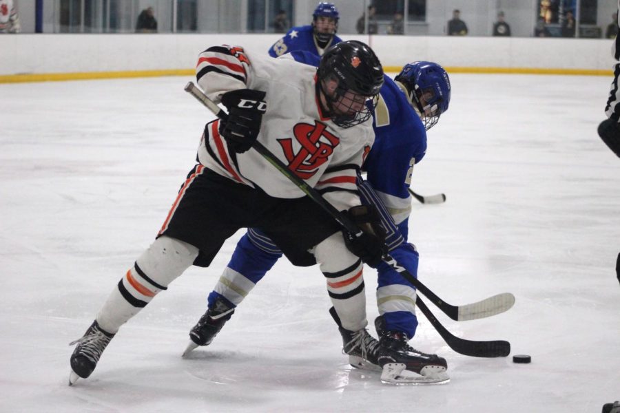 Sophmore Jack Wandmacher challenges Holy Angels player for the puck. The Park boys hockey team played against Academy of Holy Angels 7 p.m. Jan. 15 at the Rec Center.  