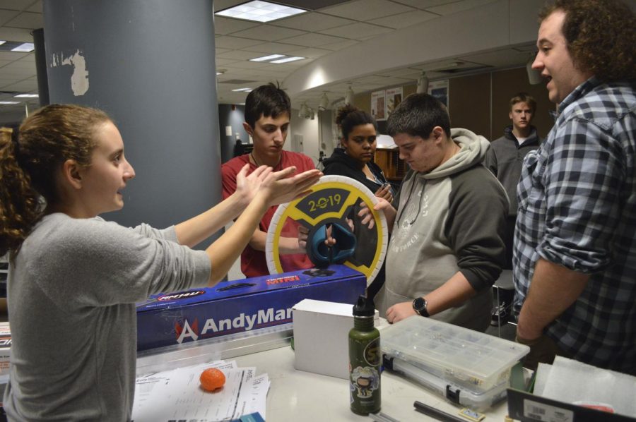 Sophomore robotics member Julia Salita discusses different ways to assemble materials with her fellow team members during a meeting Jan. 7. According to captain Anthony David, the robot has to be finished by Feb. 19 in order to compete in the Destination: Deep Space challenge.