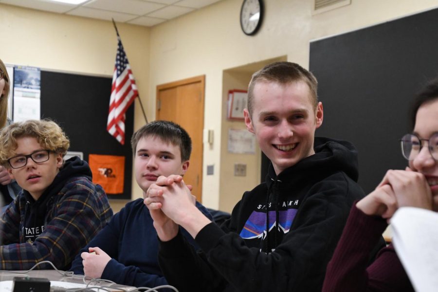 Senior Quiz Bowl member Quinn Whitlow beams alongside his teammates after accurately answering a question during Quiz Bowl practice Feb. 5. 