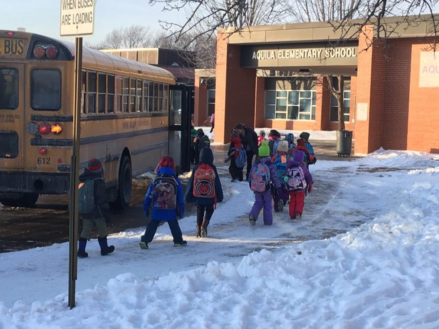 Students from Aquila board busses at the end of school Feb. 1.   Students were late in leaving school due to an extended evacuation because of a sprinkler head burst.