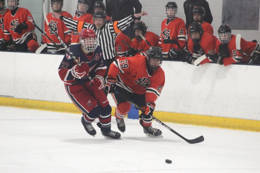 Junior Jacob Johnson races against Robbinsdale Armstrong/Copper senior Bjorn Jensen-A to get the puck. St. Louis Parks next game is against Chanhassen at 7 p.m. Feb.7 at the Victoria Ice Arena. 