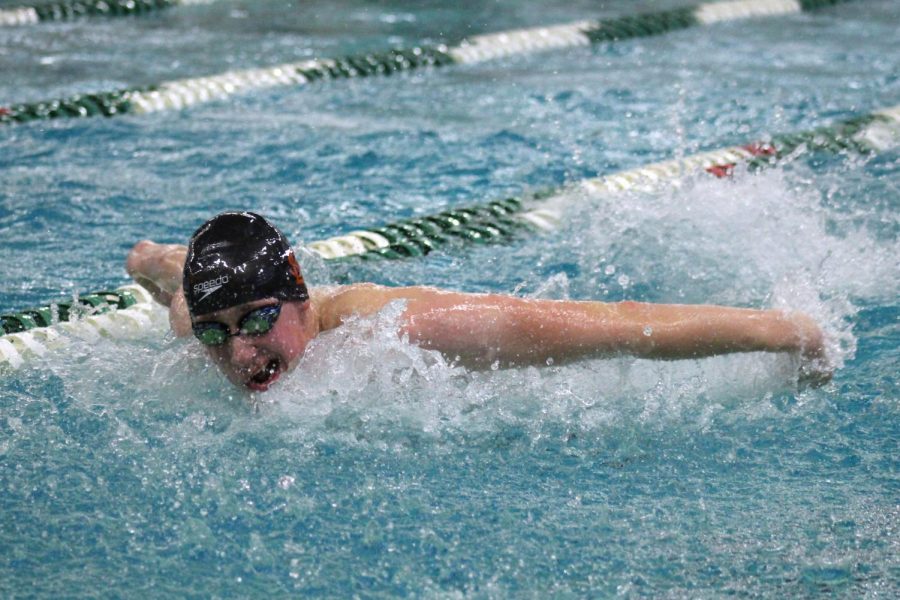 Senior Luke Anderson takes a breath during 100m butterfly race. Anderson is a part of the 200m Medley Park relay that qualified for State. 
