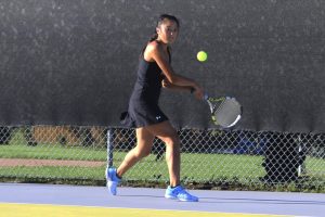 During the 2018-2019 tennis season, senior Susanna Hu returns a serve at a home match. Hu verbally committed to play Division 3 tennis at the University of Wisconsin La Crosse in February.