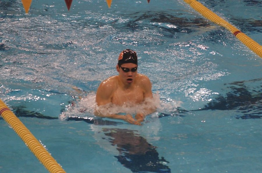 Sophomore Hayden Zheng warms up before he swims the 100 breaststroke at the AA boys swimming State meet March 5 at the University of Minnesota. 