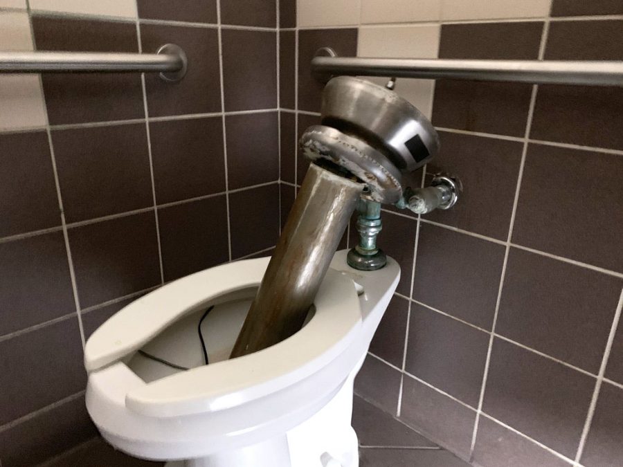 A destroyed sink placed in one of the toilets of the boys bathroom in the B3 hallway March 28. According to Meyers, the district is working on various other projects, which has slowed the repair process for vandalism in the high school bathrooms. 
