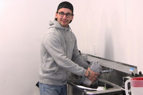 Co-founder of SLP Nutrition Alex Brose washes dishes after preparing shakes for customers. SLP Nutrition is a health club with a mission of creating a healthy community.