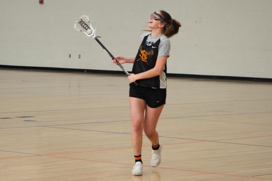 Captain Grace Lynch who is a senior cradles the ball after catching it at captains practice March 3. The next girls lacrosse captains practice is 6:30 p.m. March 11 at St. Louis Park High School.