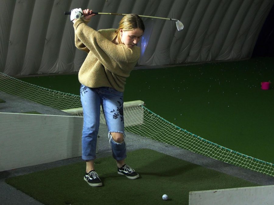 Junior Lily Rostal practices her short game at the Brooklyn Park Golf & Sports Center. Girls golf had its first practice March 18 and will have its first match at 3:00 p.m. April 8 at Bluff Creek Golf Course. 