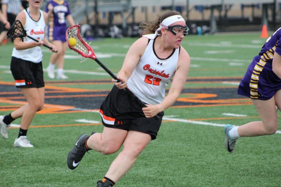 Senior Halle Weinmann carries the ball up the field during a game against Chaska May 8, 2018. Girls lacrosse tryouts for the 2019 season begin April 8.