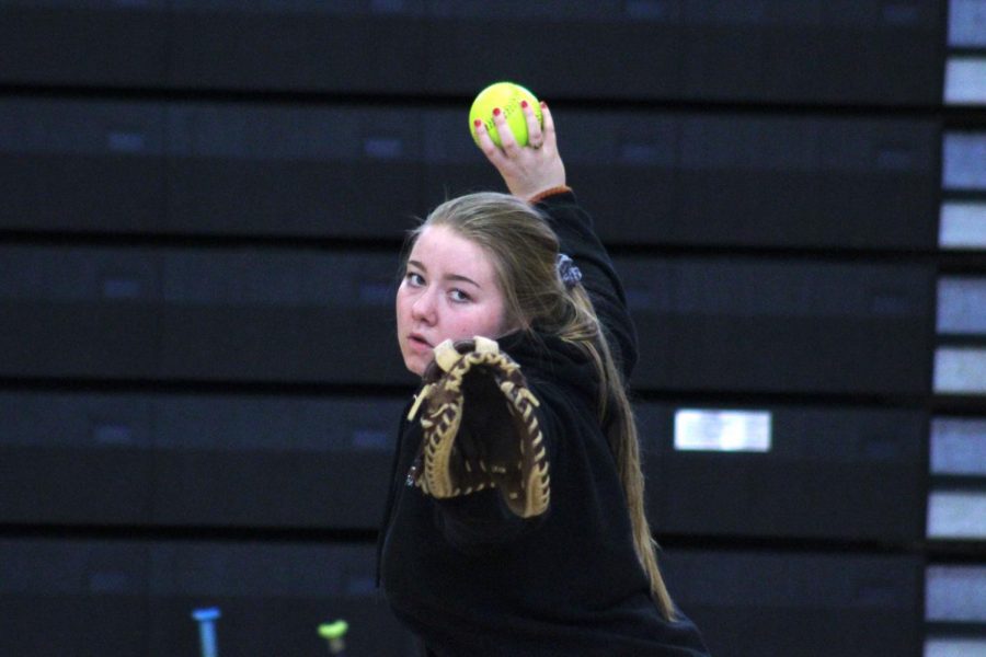 Senior Maddy Schmitz pitches the ball to a teammate during softball tryouts March 13. The teams first game will be 4:30 p.m. April 9 at New Hope Learning Center against Robbinsdale Cooper. 