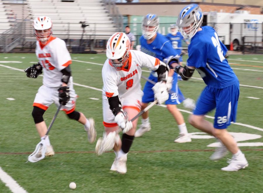 Junior Flynn Spano looks to recover the ball and avoid Hopkins attackers. After allowing four goals in the first quarter, Park allowed five more goals, and scored three, over the next three periods. The final score of the game was 4-9 Hopkins.