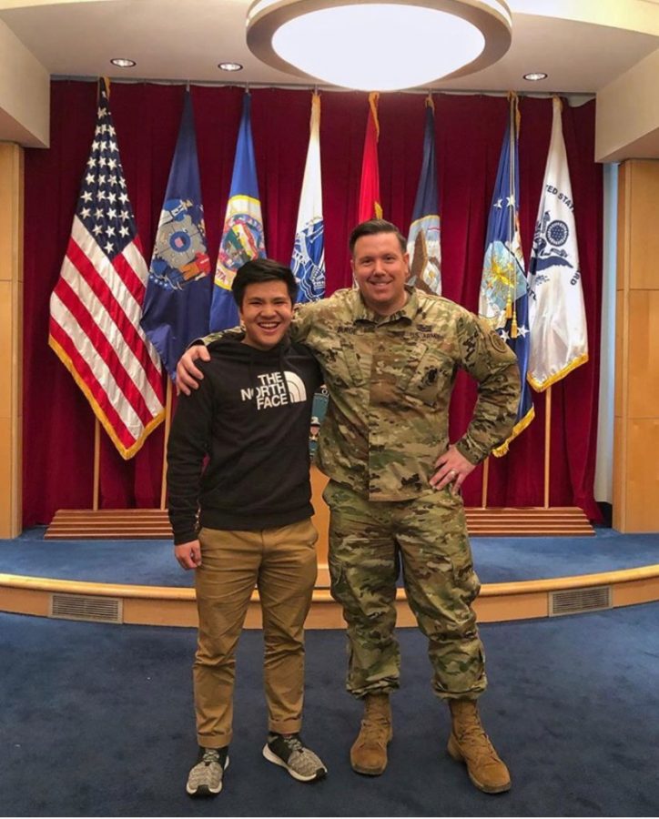 Senior Bryan Huynh poses with an United States Army personal after making his commitment.