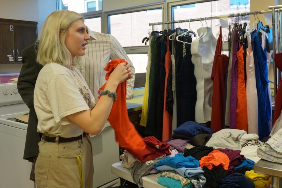 Senior Ava Townsend folds clothing in order to get The Clothing Closet ready for students. The Clothing Closet is open Tuesday through Thursday during third hour for any students looking for free secondhand clothing.