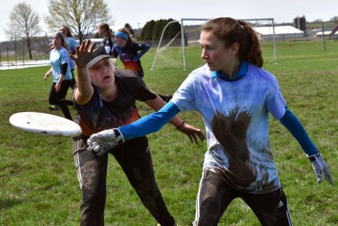 Junior Amelia Ryan attempts to defend the disc during the last game of the Madison Mudbath Tournament April 28. The next tournament will be the Hopkins Hustle Tournament May 11-12. 