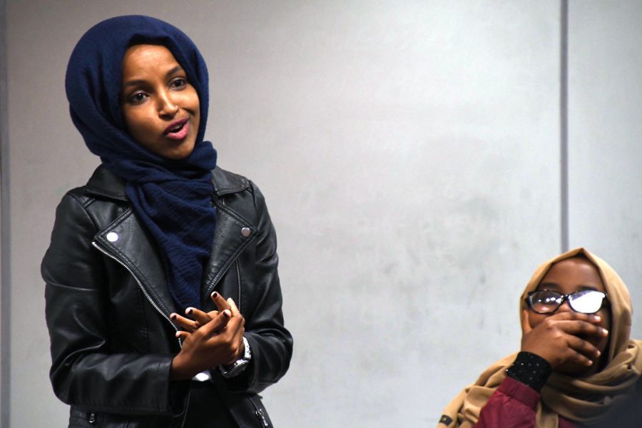 Junior Ayan Ahmed stares up at Rep. Ilhan Omar as she addresses her peers in C350. Attendees sat in a  circle that included Omar and Park students of all ages. 