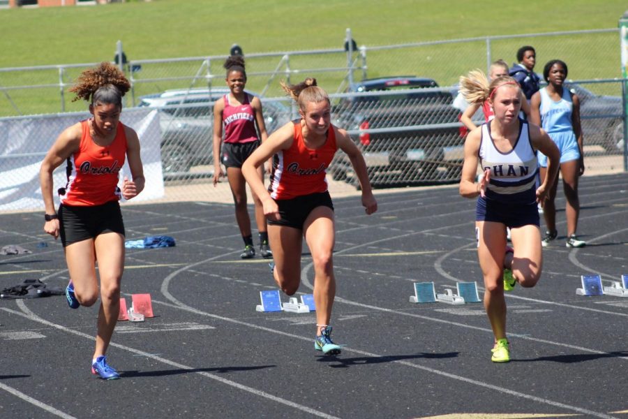 Freshman Freya Wade and junior Ava Bishop run the 100 meter during Sections May 15. The girls track and field team were Section champions.