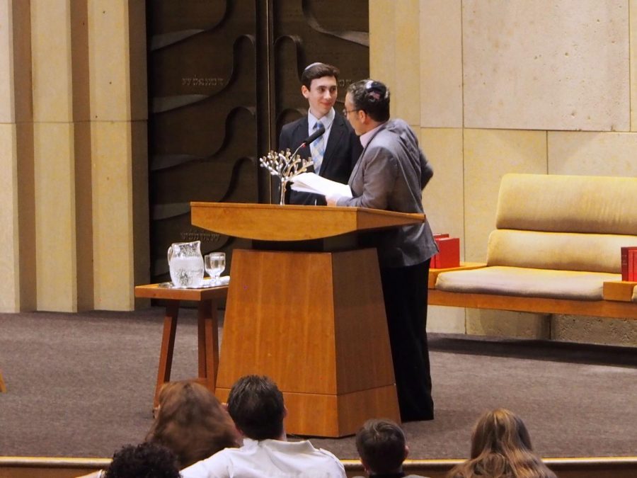 Senior Yonah Davis accepts his Howie Stillman Young Leadership Award from Joel Glaser at Adath Jeshurun Synagogue. The award is given annually to young, Jewish leaders who are active in a Twin Cities youth group.