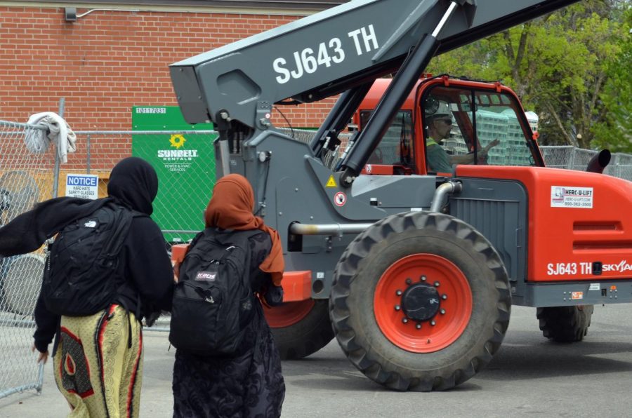Kraus-Anderson construction workers operate an SJ643 TH Skyjack reach forklift outside the St. Louis Park High School pool. Students traveling to nearby McDonalds have been forced to take different routes due to the closing of exits located on that side of the building. 