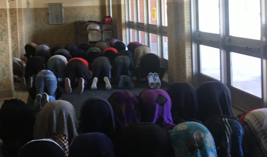 A group of Muslim students gather each day in the Dakota Foyer to pray duhur, the required noon prayer. A new location was recently chosen by staff which has given students an area to pray during the school day.