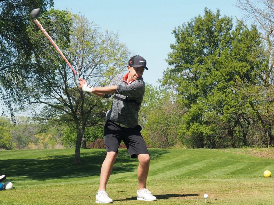 Senior Owen Goddard winds up for a swing at the second hole during a match against Minneapolis Southwest May 15. The next match will be at the Minneapolis Golf Club May 19.